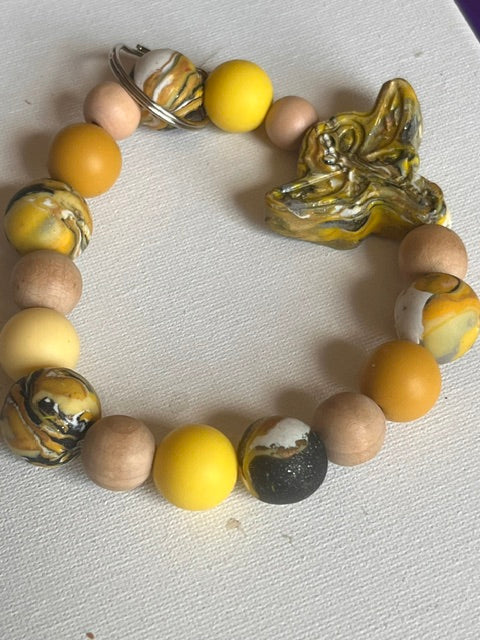 Hufflepuff-themed large beaded keychain with yellow and marbled beads and a golden flying key charm